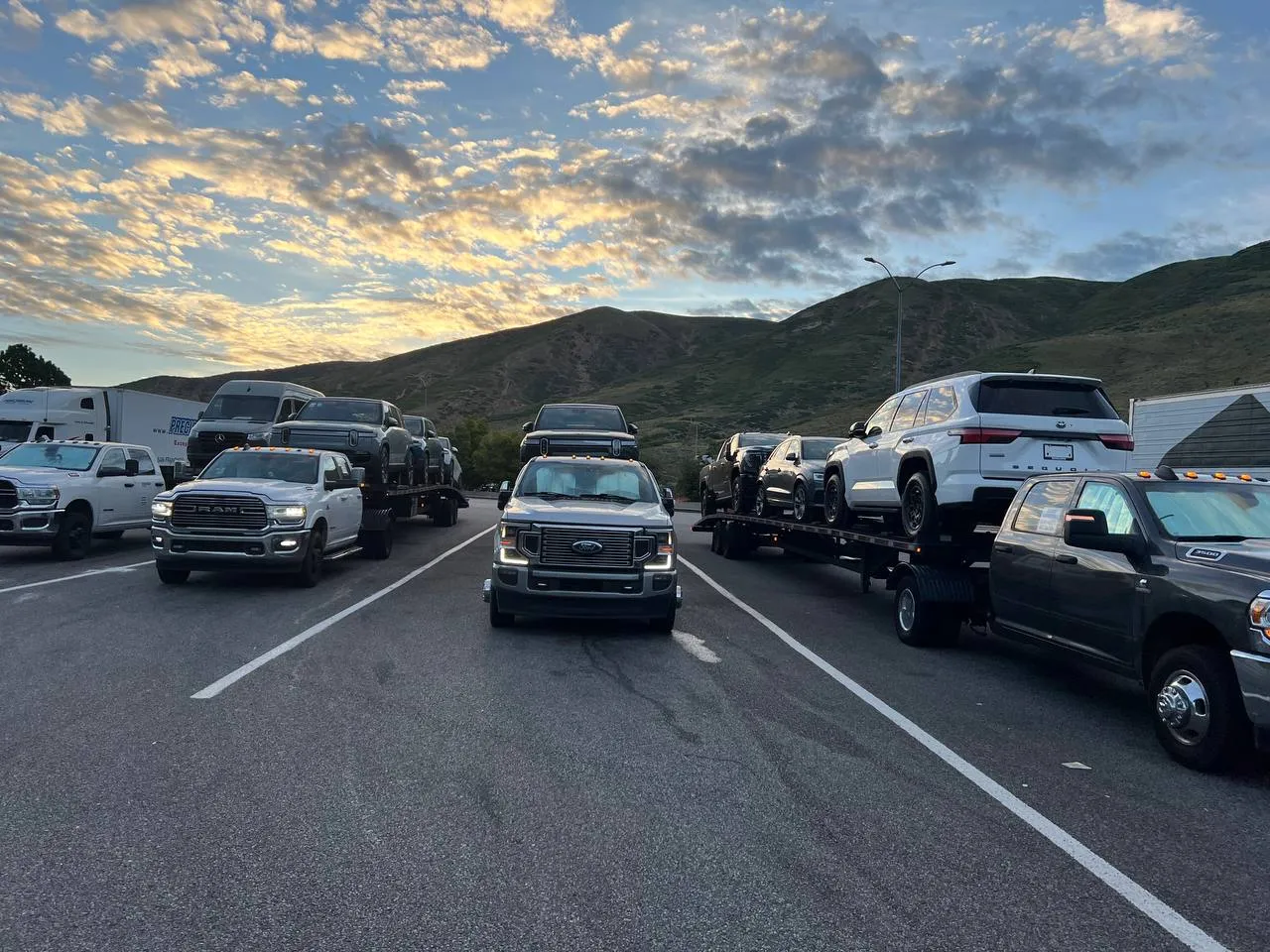 Vehicles secured on an open transport trailer